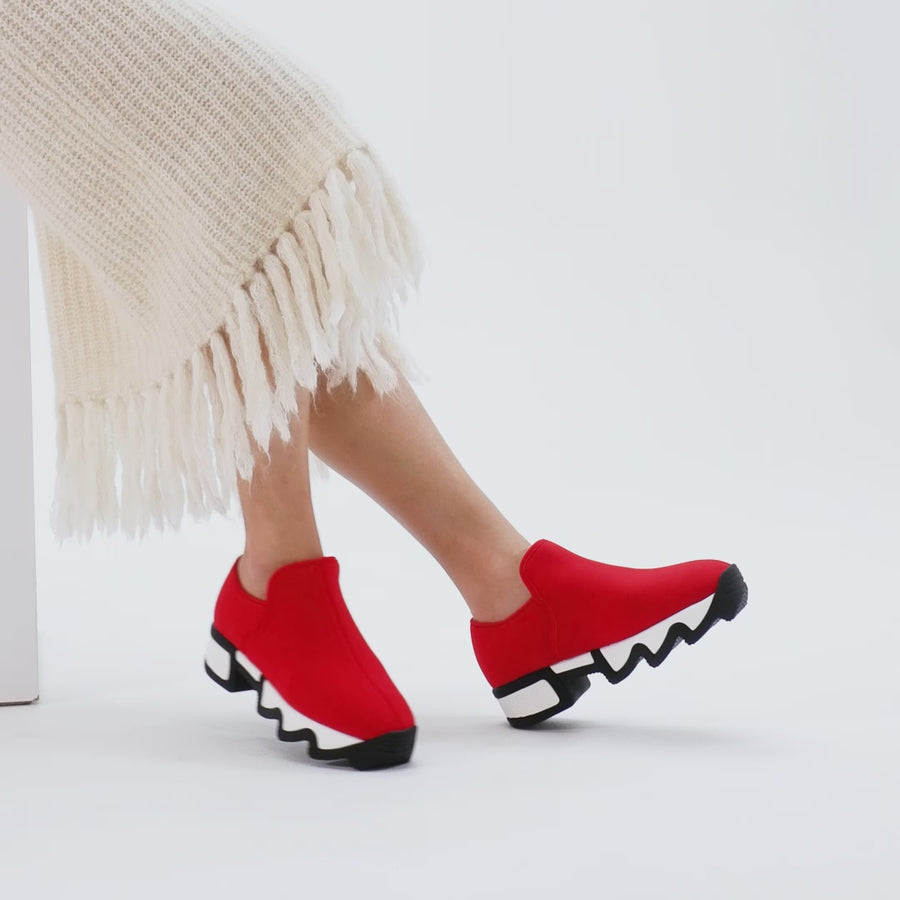 WES Red Low Top Sneaker on a walking model wearing white skirt